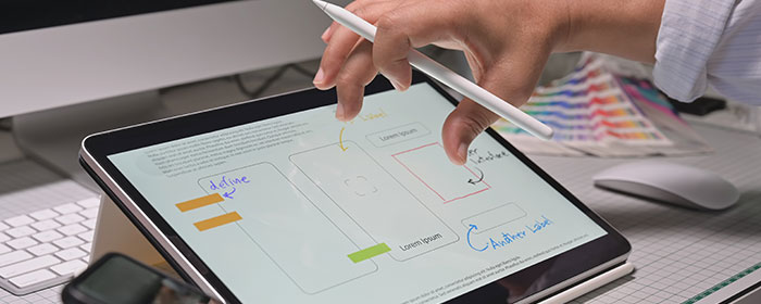 Affordable e-commerce website design in Pakistan, showcasing a modern tablet interface with planning sketches.